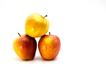three apples stacked on each other in a triangle
