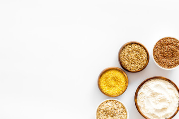 Healthy food concept. Cereals in bowls on white background top view frame copy space