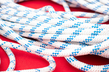 A closeup shot of wrapped polyester rope line on a red table.