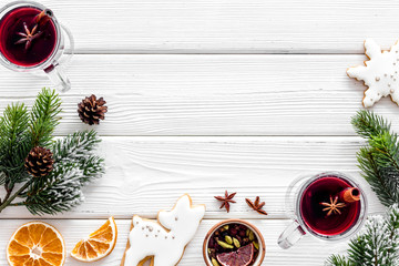 Background with mulled wine and New Year decoration on white wooden background top view frame copy...