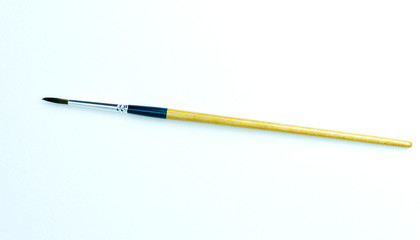 Paintbrush painted on white paper background..