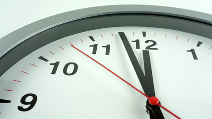 Gray wall clock face beginning of time 11.58 am or pm on White background, Copy space for your text, Time concept..
