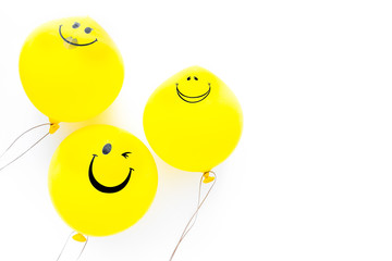 Happiness emotion. Yellow balloon with smile on white background top view space for text