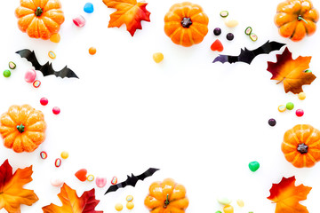 Obraz na płótnie Canvas Halloween composition with sweets on white background top view frame space for text