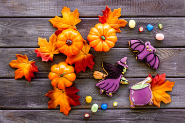 Nice halloween background with sweets. Cookies and pumpkins on dark wooden top view