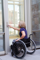 Woman in Wheelchair Opening Door