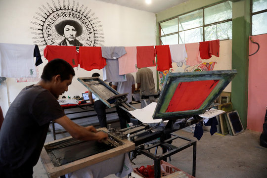 A student of the Ayotzinapa teachers' training college 'Raul Isidro Burgos' works at a serigraph workshop days before the fifth anniversary of the disappearance of 43 students from the collegue, in Tixtla
