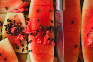  people  cutting watermelon into  piece for background.