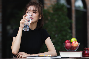 Asia woman drinking water with happy.