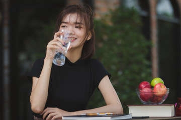 Asia woman drinking water with happy.