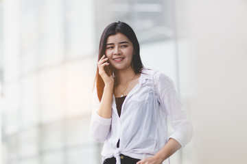 Asia woman using smartphone working,playing with happy.