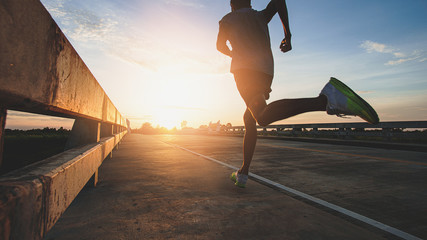 Athlete runner feet running on road, Jogging at outdoors. Man running for exercise.Sports and healthy lifestyle concept.