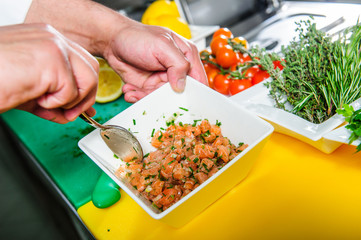 Salmon sashimi spicy salad cooking by cheef in the restaurant .