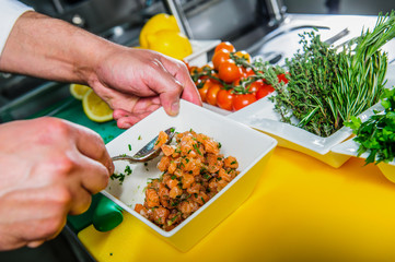 Salmon sashimi spicy salad cooking by cheef in the restaurant .