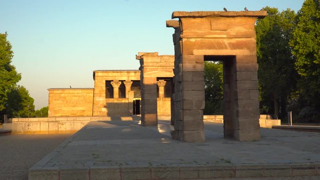 Locked off view over Egyptian Temple of Debod in Madrid, Spain with shadows moving at sunrise
