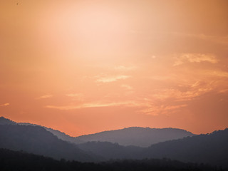 Fototapeta premium Beautiful orange sunset over the mountain, orange sky