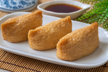 Rice ball wrapped in deep fried tofu pouches (Inari Sushi), Japanese food.