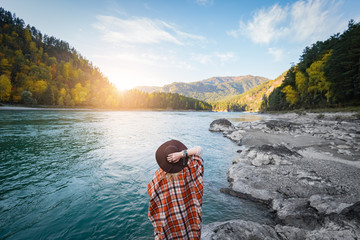 Autumn woman standing backwards and watching nature.