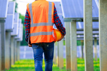  Solar power plant,engineers walking in the solar energy panels,Technician with field of solar panels