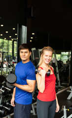 Young couples work out at the gym to strengthen the body. Each person recommends exercise for each other and encourage each other while exercising.