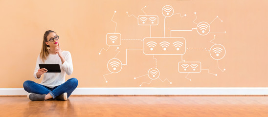 Wifi with young woman holding a tablet computer