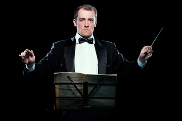 Studio photo of music conductor holding his baton