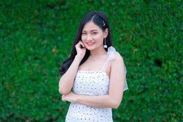Fototapeta premium Portrait of Beautiful young woman with summer green park background