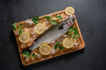 Crumbled ice cubes and fresh aconite on wooden tray