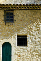 Fototapeta na wymiar facade of mediterranean building with stone wall