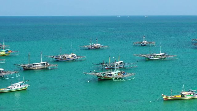 Aerial Drone Video flying above Fishing Village of Tanjung Binga in Belitung Island Indonesia. Fishing Boat on Clear water, village houses