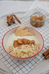 yogurt with cooked pears and home made granola on a table