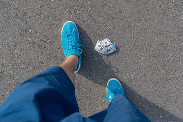 person find paper money lost and dropped on the asphalt ground outdoor