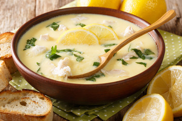 Thick aromatic Greek lemon soup with chicken and orzo paste close-up in a bowl. horizontal
