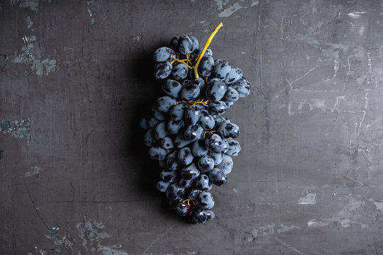 Ripe black grape on the rustic background. Selective focus. Shallow depth of field.