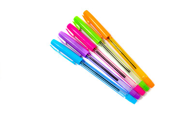 ballpoint pens of different colors on a white background