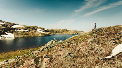 Tourist taking photo in norwegian nature