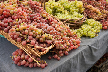 Fresh seedless grapes on display in an outdoor farmers market in North America.