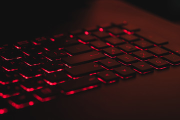 Obraz premium Red backlit keyboard buttons in red light. concept alarm.