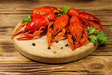 Boiled crayfish on cutting board on wooden table