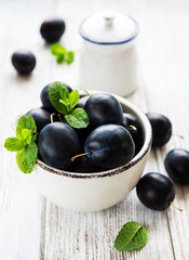 Bowl with fresh plums