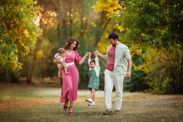 Naklejka premium Happy family: mother, father, children son and daughter on nature have a fun on summer day