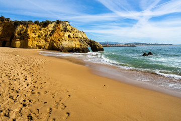 Scenic view of Batata beach (Praia da Batata) with with typical golden cliffs e footprints on the...