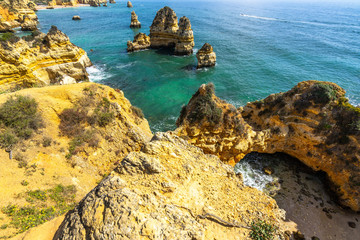Typical limestone cliffs of Algarve coast near Praia do Camilo beach, Portugal