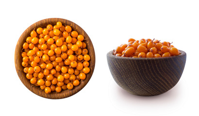 Sea buckthorn. Seabuckthorn in a wooden bowl isolated on white. Fresh ripe berry with leaves isolated on white background. Top view. Orang berry on white.