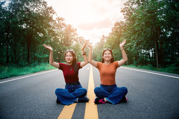 portrait of young girls take a deep breath on road at countryside