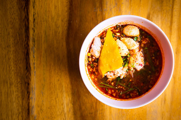 thai style spicy noodle on wooden table