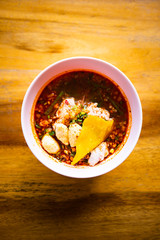thai style spicy noodle on wooden table