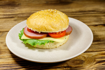 Fresh delicious homemade cheeseburger on wooden table