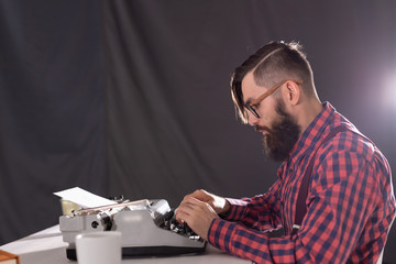 People and technology concept - Portrait of writer working on typewriter