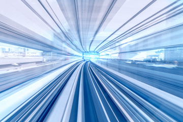 Motion blur of speed train moving in tunnel with light at end